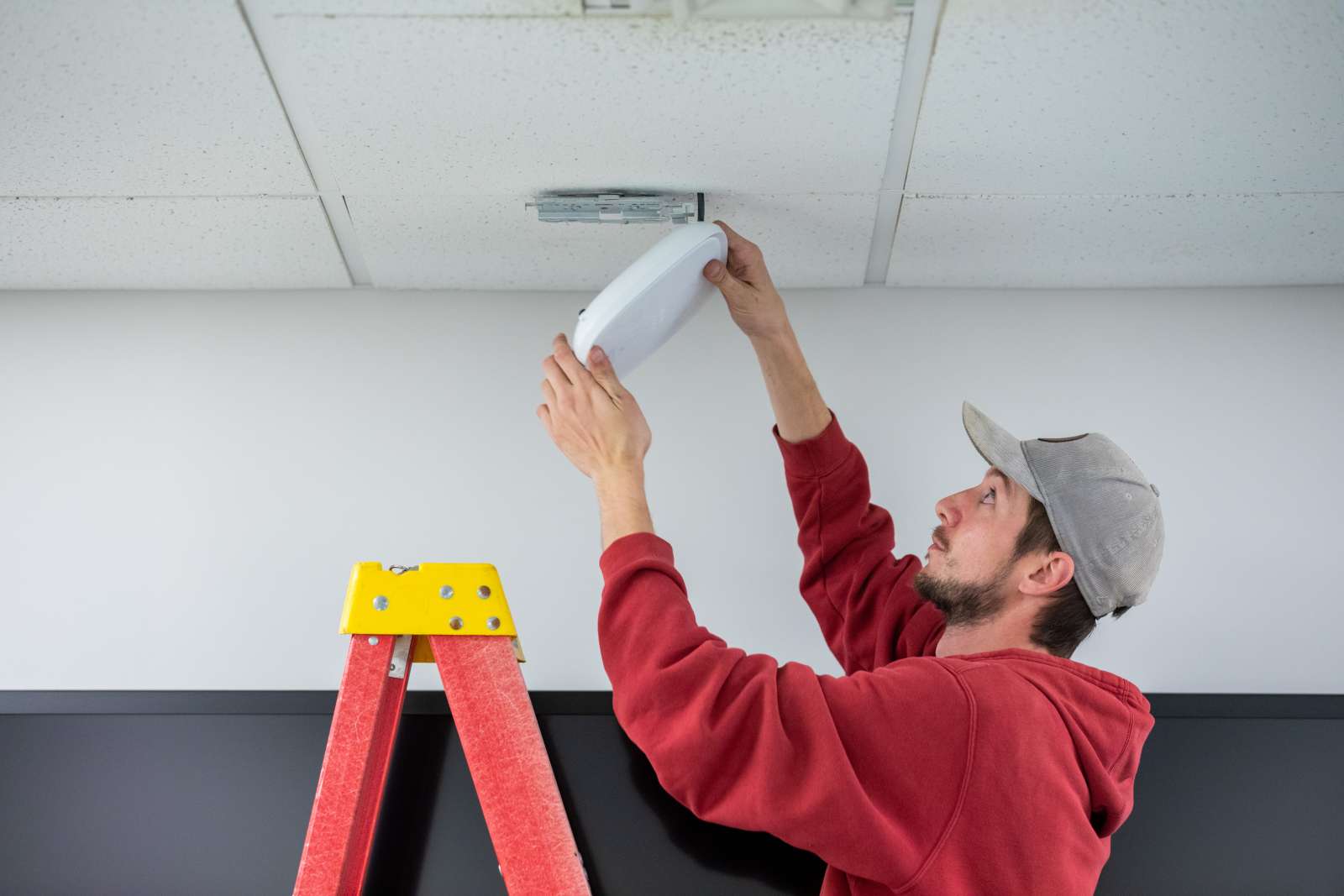 IT technicians installing an access point. 